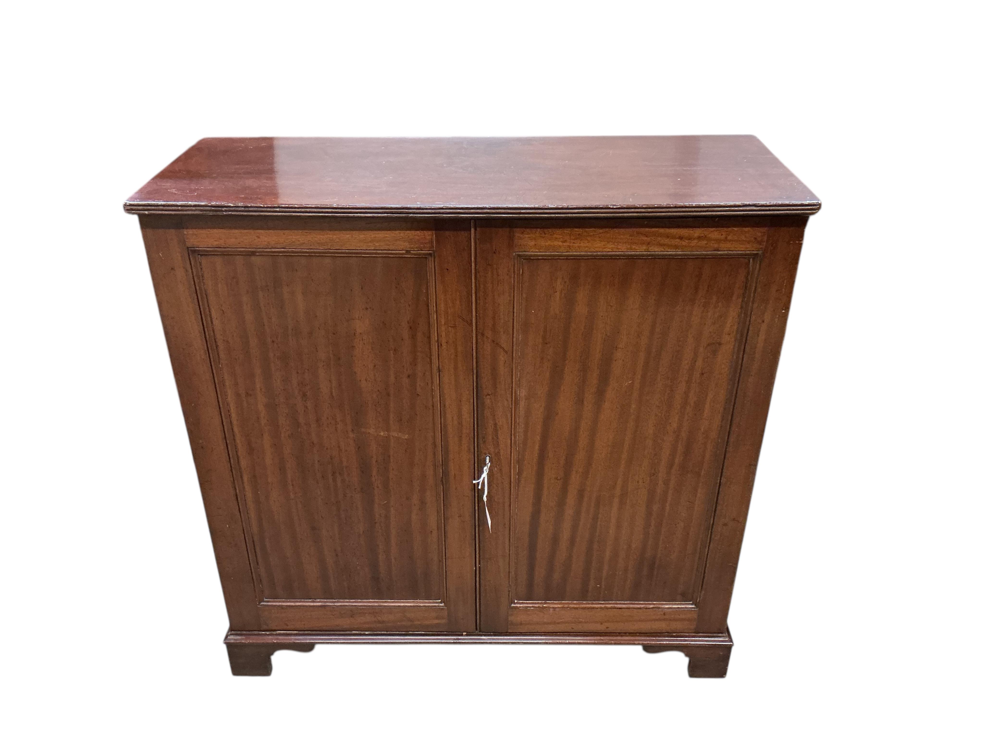 An early 19th century mahogany two door side cabinet, width 103cm, depth 37cm, height 104cm